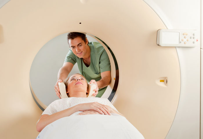 A radiologist performing a CT scan on a patient