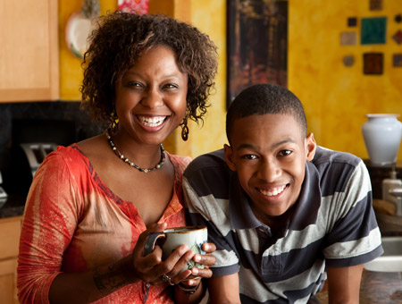 Photo of a relaxed and smiling teenage son with his mother